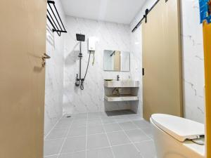 a white bathroom with a sink and a toilet at Tiffany Resident Apartment in Siem Reap +37 photos