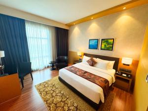 a hotel room with a large bed and a desk at The Light Hotel Penang in Perai +127 photos