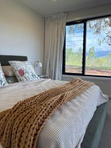 a bedroom with a large bed with a large window at Silk & Oak in Darlington