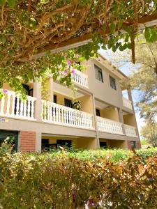 a large white building with a balcony at Royal Lake View Gardens in Kampala