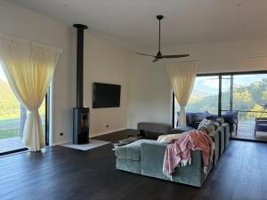 a living room with a couch and a flat screen tv at Silk & Oak in Darlington