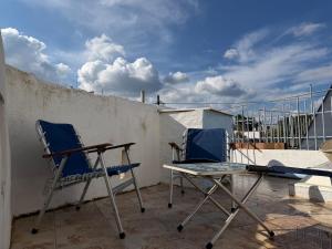two chairs and a table on a balcony at Patrick's Traditional Home in Pyrgi