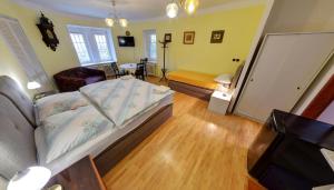 a bedroom with a bed and a living room at Pension Siesta in Třeboň