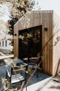 a wooden building with a table and a bench at Tiny Chalet in Blankenburg +3 photos
