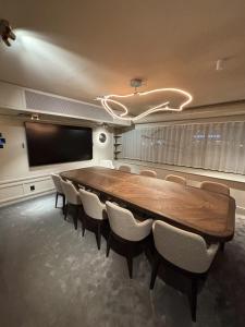 a conference room with a large wooden table and chairs at Thon Hotel Vasa in Stockholm