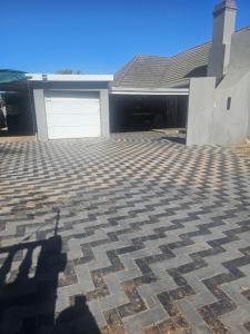 a house with a driveway with a garage at Ludiz Self Catering Guest House in Avondale