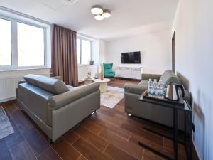 a living room with a couch and a tv at Rezidence Třebíč in Třebíč
