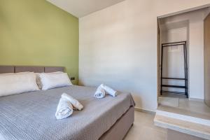 a bedroom with a bed with two pillows on it at Rubick solari studio in Mantoúkion