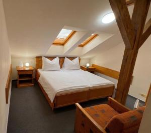 a bedroom with a large bed in a attic at Brezina Pension in Prague