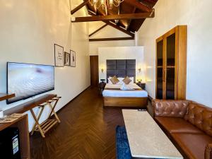 a living room with a bed and a couch at Gulf Hotel Mumbai- The Boutique Hotel Colaba Mumbai in Mumbai