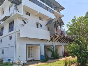 a building with a bird on the side of it at Coorg rest house in Madikeri