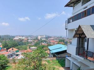 a view of a city from a building at Coorg rest house in Madikeri +4 photos