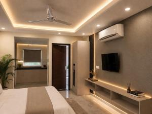 a bedroom with a bed and a flat screen tv at OPO Premier Marvel in Jaipur