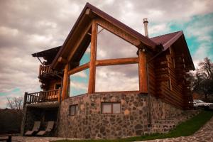 a house with a large window on the side of it at Nomad Escape Bran in Sohodol