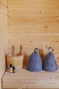 two bells sitting on a shelf in a sauna at Dom przy Lesie z sauną in Augustów