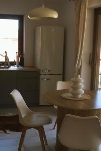 a kitchen with a table and chairs and a refrigerator at Dom przy Lesie z sauną in Augustów +12 photos