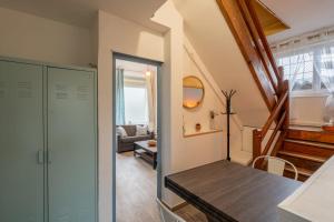 a room with a hallway with a staircase and a living room at Le Sostranien - Jardin - Wifi in La Souterraine