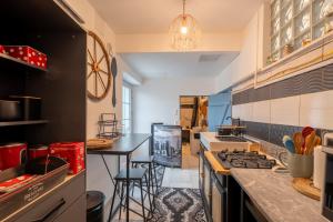 a kitchen with a stove and a counter top at Le Sostranien - Jardin - Wifi in La Souterraine