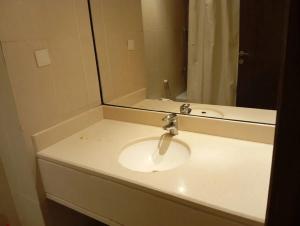 a bathroom counter with a sink and a mirror at Room Al-Malaz in Riyadh