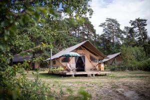 a tent with a person standing inside of it at Huttopia Bourg St Maurice in Bourg-Saint-Maurice