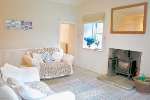 a living room with a couch and a fireplace at Little Dunbar in Dumfries