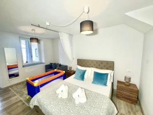 a bedroom with two beds with blue and white pillows at Laglio Cloud Nine, Como Lake in Laglio