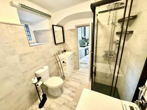 a bathroom with a toilet and a glass shower at Laglio Cloud Nine, Como Lake in Laglio