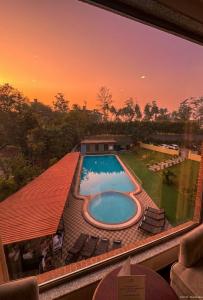 a view of a swimming pool from a window at Hotel Tania Searock in Daman +34 photos