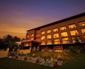 a large building with plants in front of it at Hotel Tania Searock in Daman