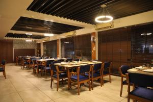 a large dining room with tables and chairs at Hotel Tania Searock in Daman