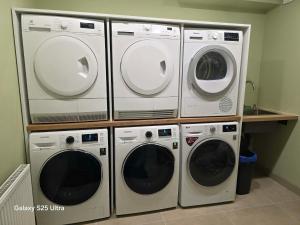 a group of four washers and dryers in a room at D20 apartamentai in Mažeikiai