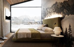 a bedroom with a bed and a large window at Wieshof Wilder Kaiser by ALPS RESORTS in Söll