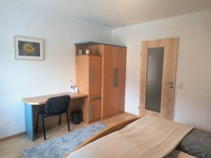 a bedroom with a desk and a bed and a cabinet at Apartment Alpenblick Lienz in Lienz