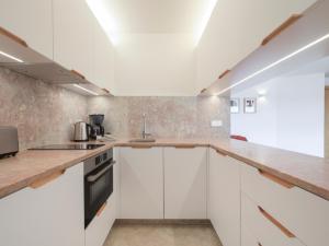 a kitchen with white cabinets and a counter top at LSA Príncipe Real by Numa in Lisbon