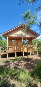 a large wooden house with a roof at Tctc & Camp in Shikurufumi