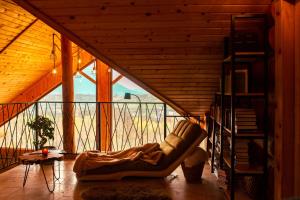 a living room with a couch in a wooden room at Nomad Escape Bran in Sohodol