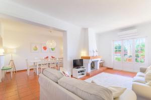 a living room with a couch and a table at Casa Buganvília in Sines