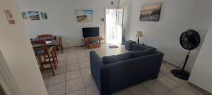 a living room with a blue couch and a table at Black Rock Haven in Scottburgh