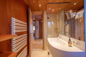 a bathroom with a sink and a large mirror at Marktlhütte in Hochrindl +222 photos