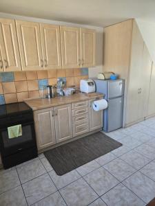 a kitchen with a sink and a refrigerator at Domek Beskid Żywiecki in Rycerka Dolna