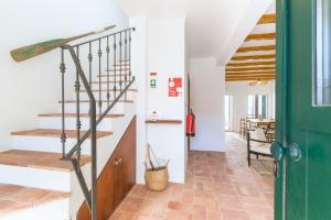 a hallway with a staircase in a house at Casa Sol Limão in Zambujeira do Mar