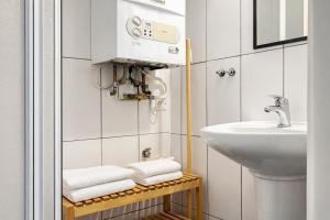a bathroom with a sink and a toilet and towels at Symbiola River Apartments in Děčín +113 photos