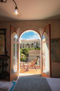 an open door to a patio with a chair outside at Maison de l'Arte di Bà in San Nicola Arcella