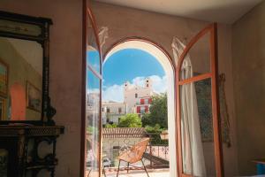 an open window with a view of a building at Maison de l'Arte di Bà in San Nicola Arcella