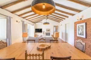 a dining room with a table and a living room at mount of the two paths in Santiago do Cacém +47 photos