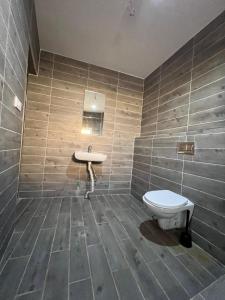 a bathroom with a toilet and a sink at Appart Hôtel Signature in Taza +100 photos