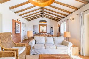 a living room with a couch and a table at mount of the two paths in Santiago do Cacém