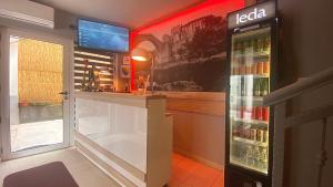 a refrigerator filled with drinks next to a window at "VILLA DENY" Boutique HOTEL - with FREE PARKING in Mostar