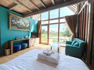 a bedroom with a bed and a large window at Nglaras Resort Yogyakarta in Ngaglik +114 photos