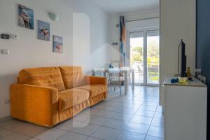 a living room with a couch and a table at Homiday - Appartamenti I Gabbiani in Pineto